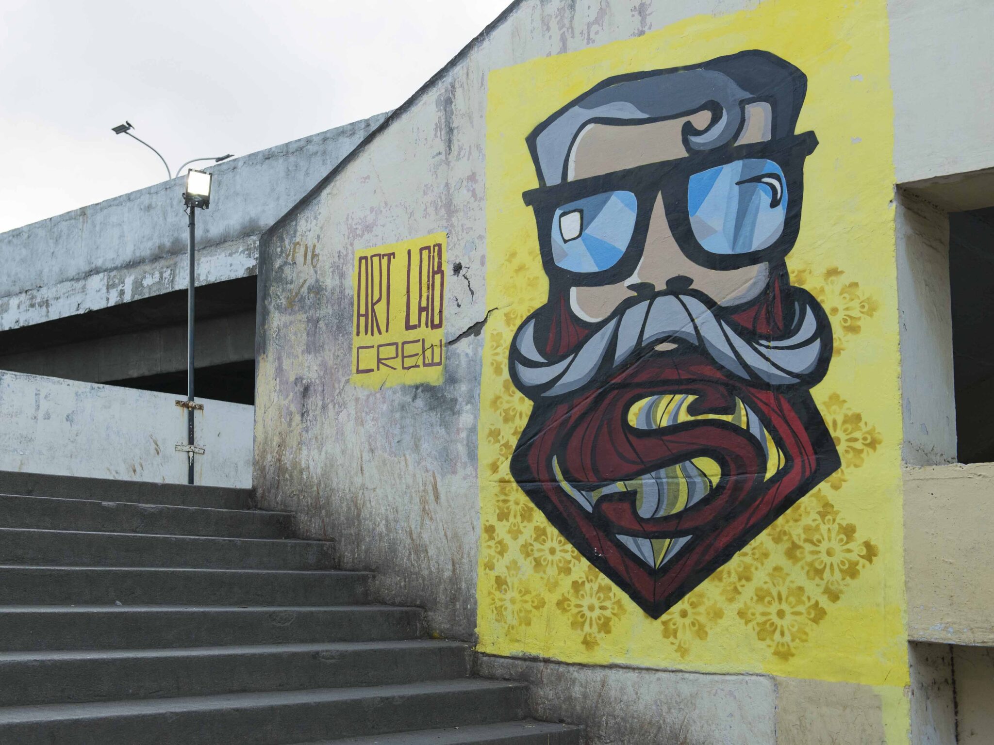 Mural of a man with th superman sign in the beard
